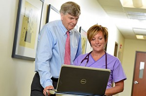 Physician and nurse consulting about cancer care for a patient